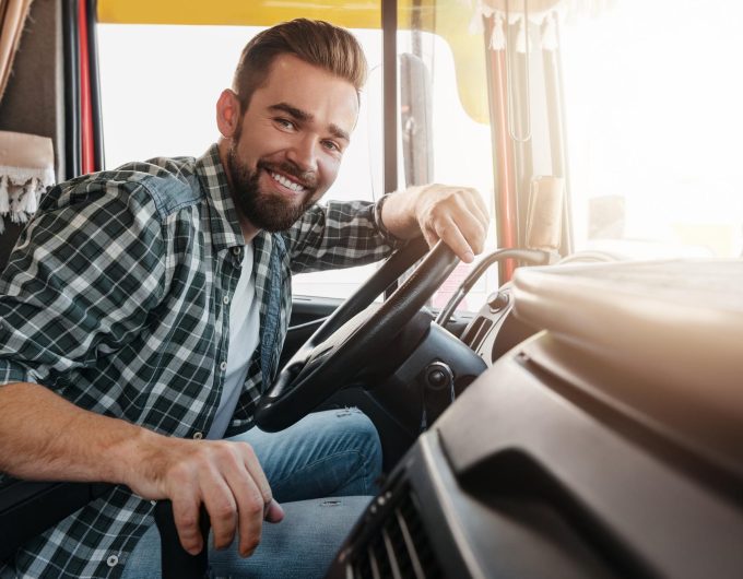 young-happy-smiling-truck-driver-inside-his-vehicle